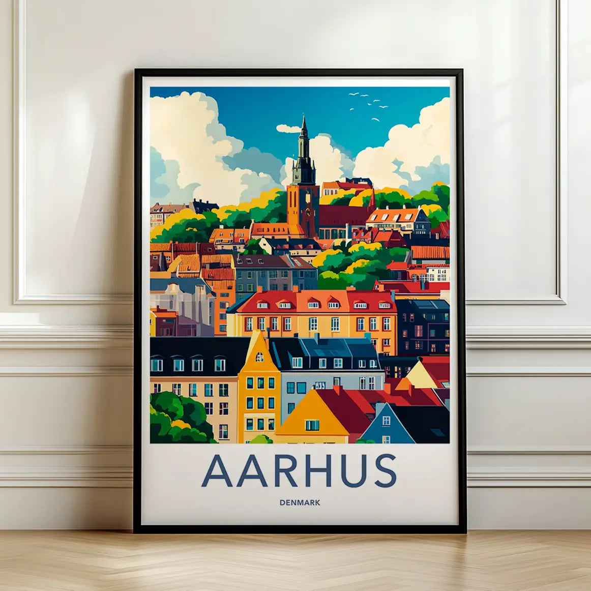 Framed travel poster of Aarhus's colorful harbor buildings and boats leaning against a white wall.