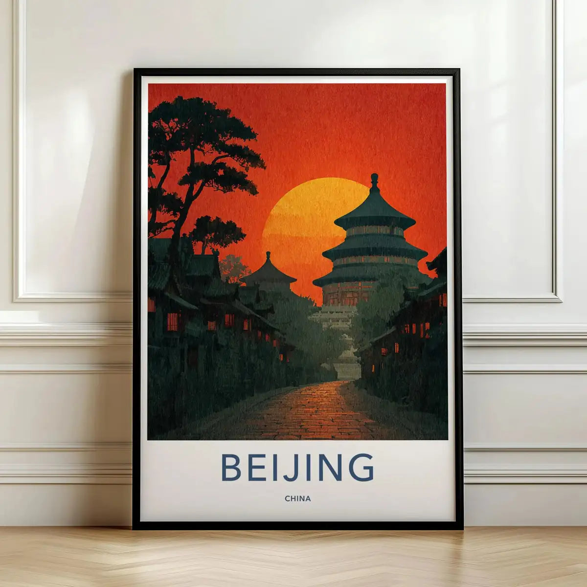 Framed travel poster of Beijing's Temple of Heaven at sunset leaning against a white wall.