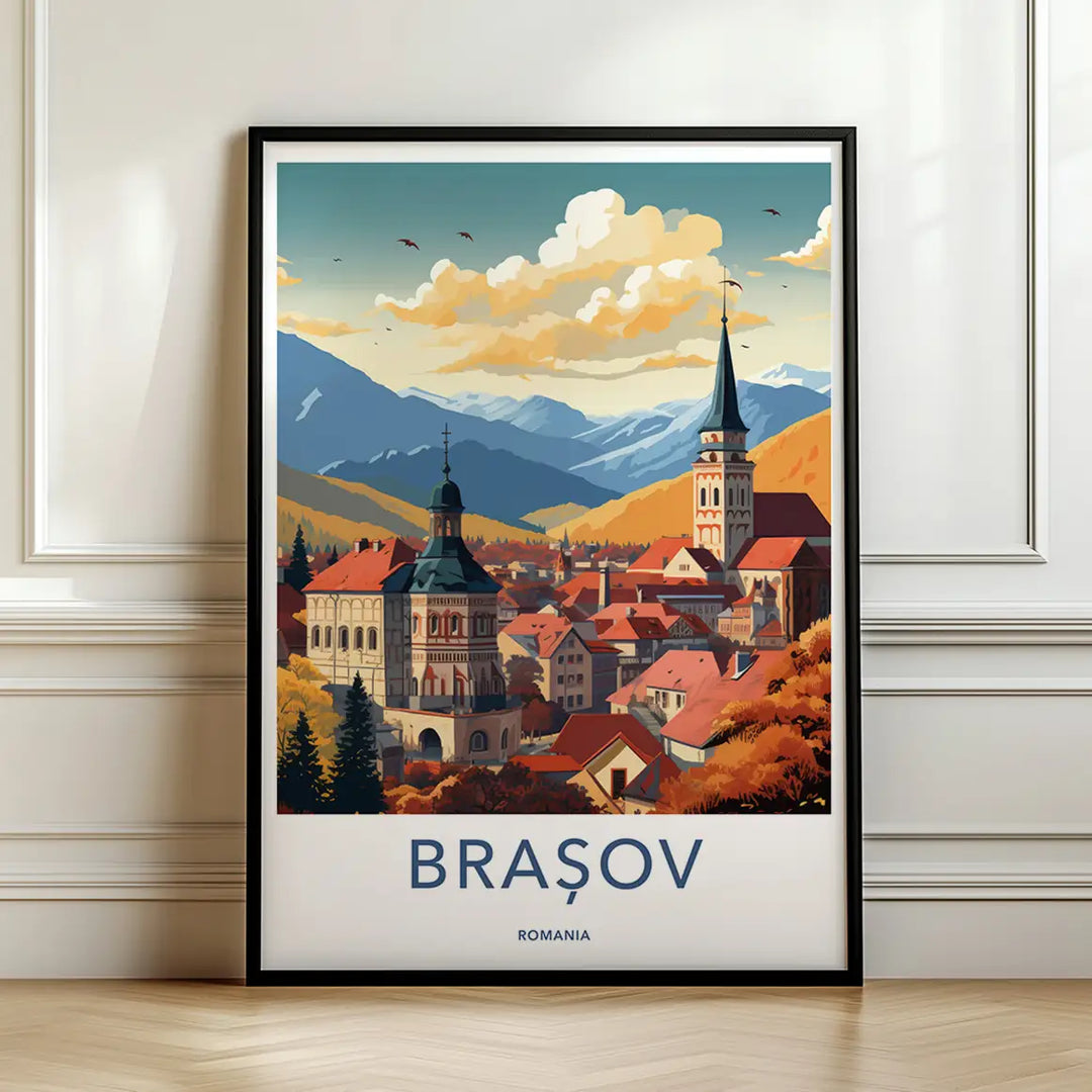 Framed travel poster of Brasov's historic town square and orange roofs against mountain peaks leaning against a white wall.