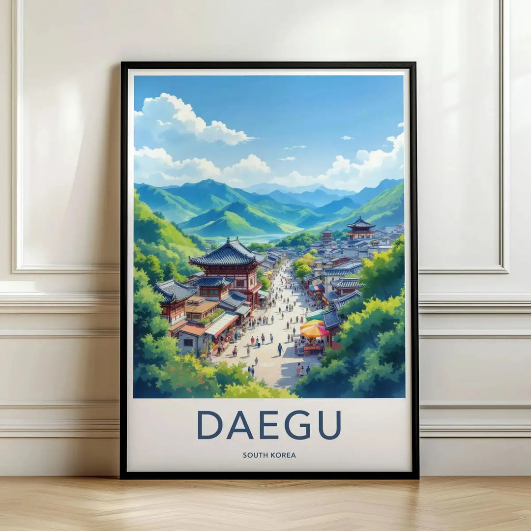 Framed travel poster of Daegu's traditional temples set against a mountain backdrop leaning against a white wall.