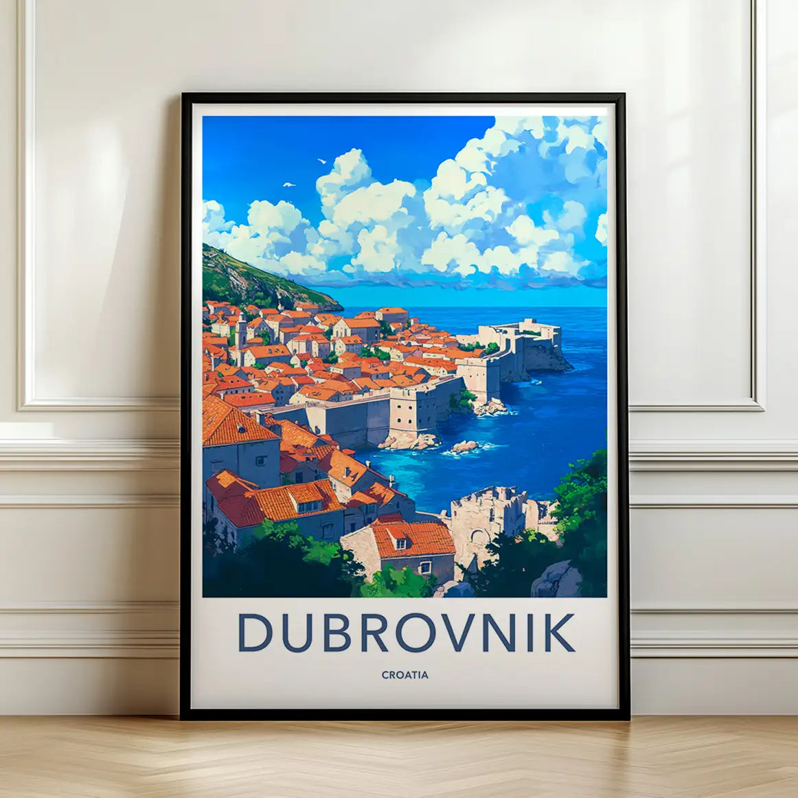 Framed travel poster of Dubrovnik's walled city and orange roofs overlooking the sea leaning against a white wall.