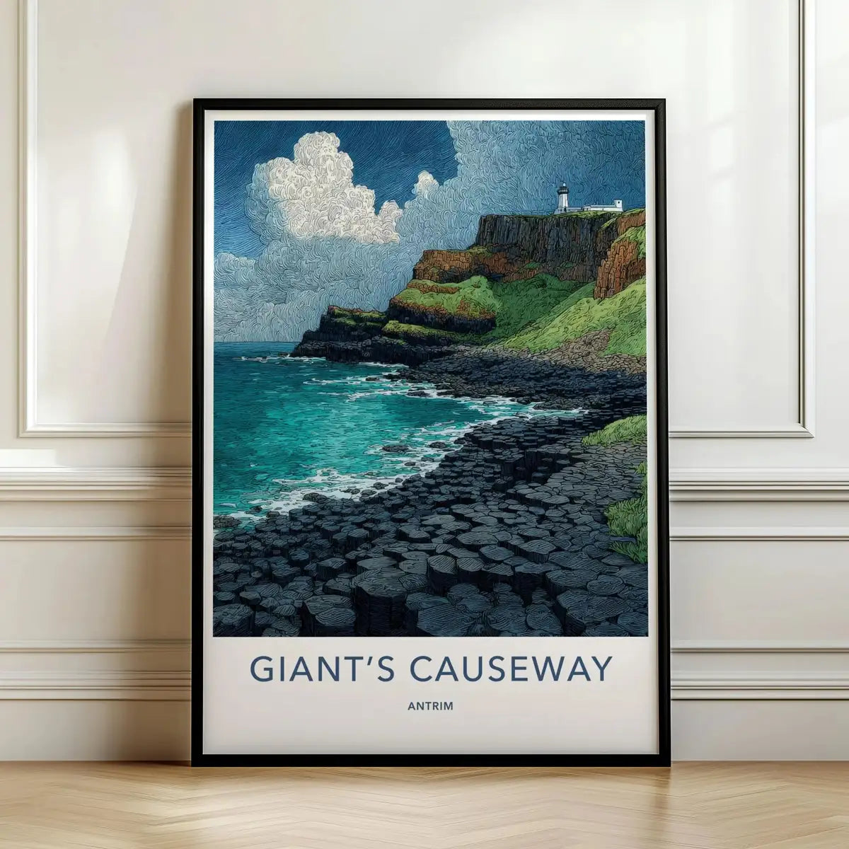 Framed travel poster of the Giant's Causeway basalt columns by the ocean leaning against a white wall.
