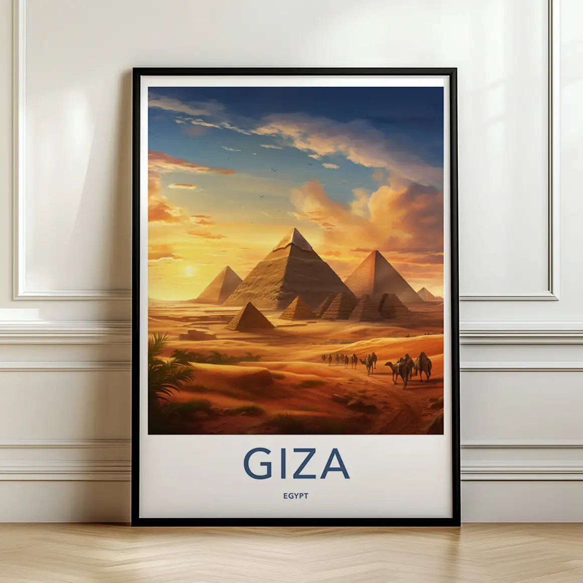 Framed travel poster of the Giza pyramids glowing in the desert at sunset leaning against a white wall.