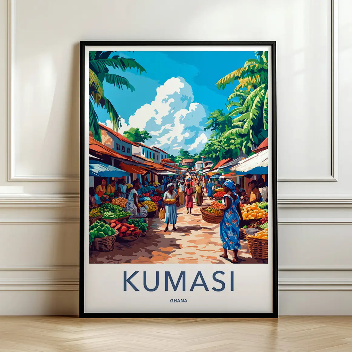 Framed travel poster of Kumasi's bustling and colorful outdoor market scene leaning against a white wall.