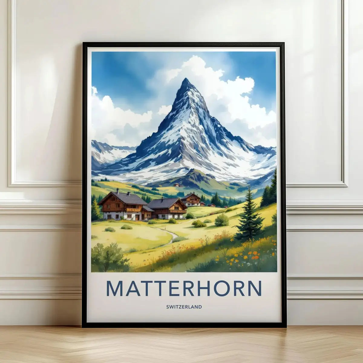 Framed travel poster of the snowy Matterhorn peak towering over an alpine valley leaning against a white wall.
