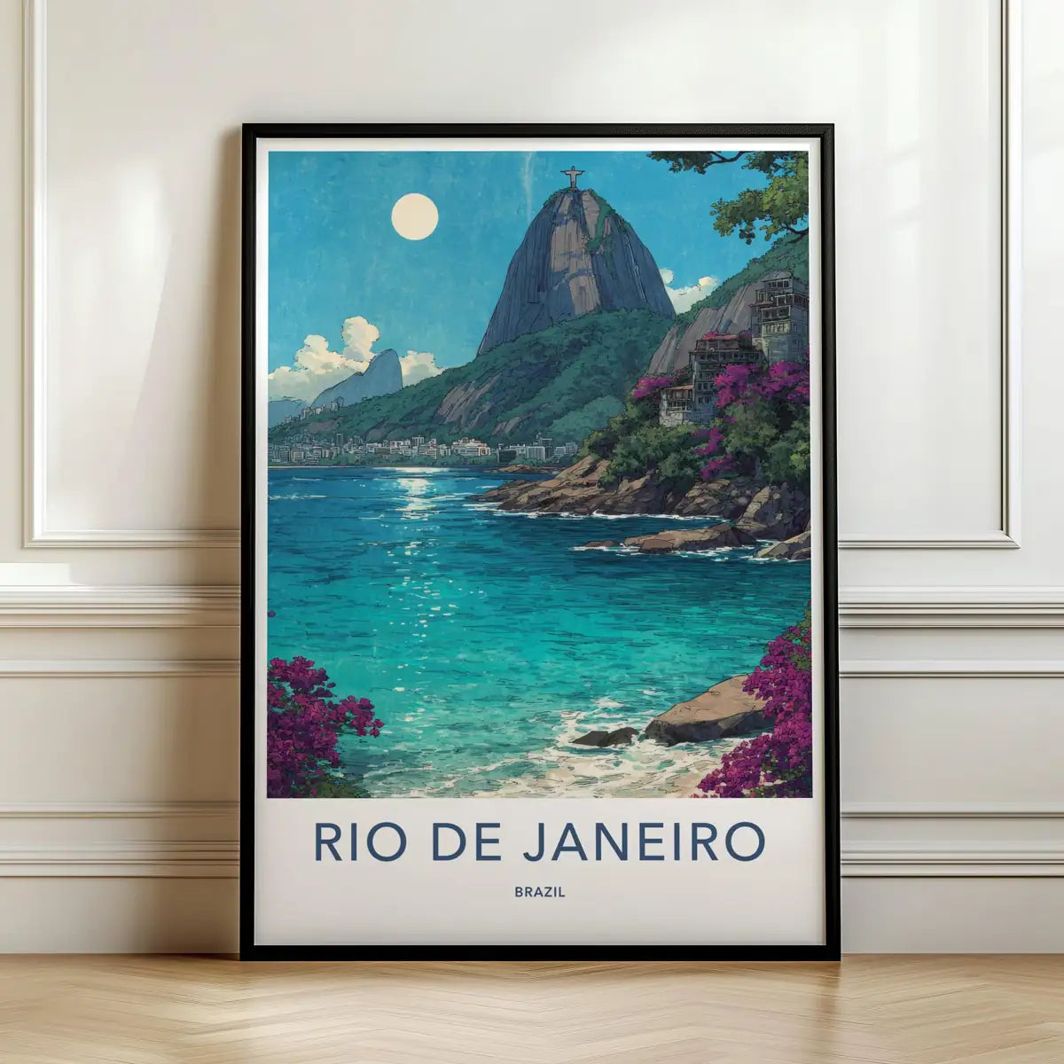 Framed travel poster of Rio de Janeiro's Sugarloaf Mountain and tropical bay leaning against a white wall.