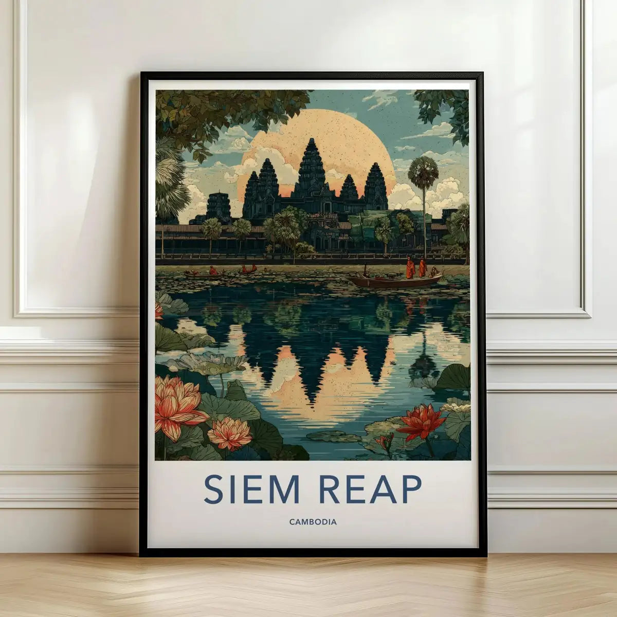 Framed travel poster of the ancient Angkor Wat temple ruins at sunrise leaning against a white wall.