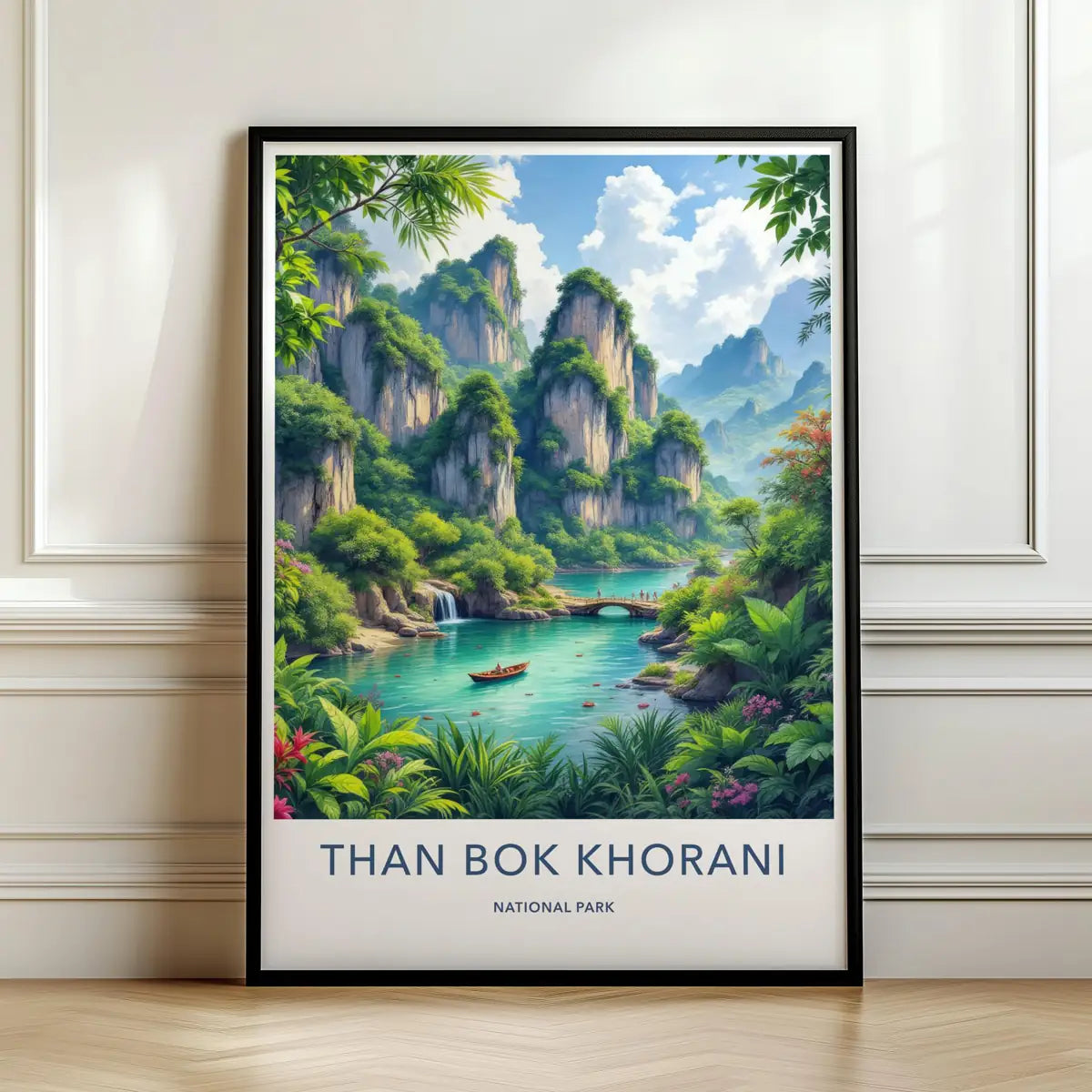 Framed travel poster of Than Bok Khorani's lush green waterfalls and natural pools leaning against a white wall.