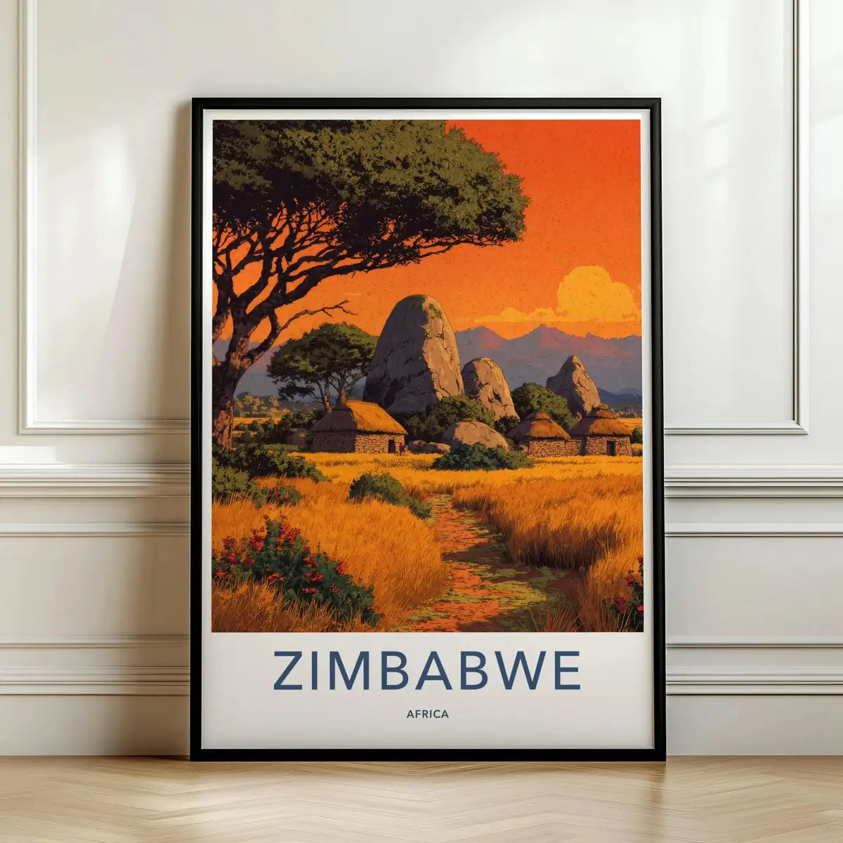 Framed travel poster of Zimbabwe's balancing rocks and savanna landscape at sunset leaning against a white wall.