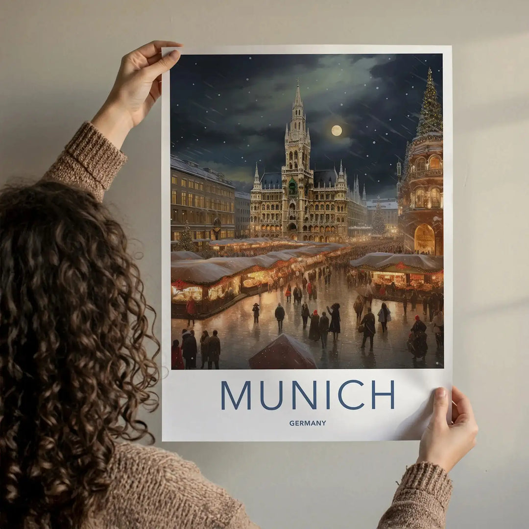 Person holding a poster of Munich with a festive market scene.
