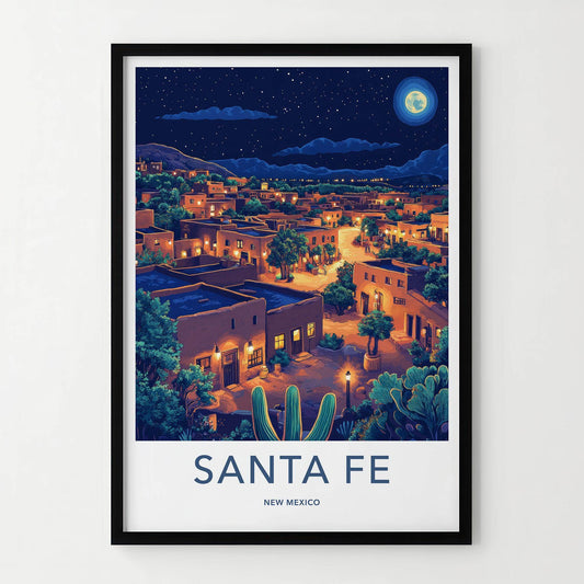 A framed travel poster of Santa Fe, New Mexico, featuring a stylized night illustration of the town with adobe buildings, cacti, and a full moon, presented in a black frame.